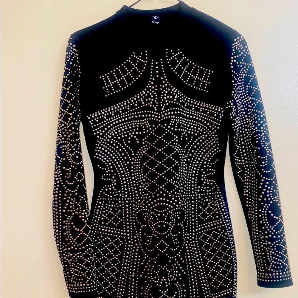 Black long-sleeved mock neck dress from Windsor. Gold detail with zipper back.